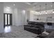Open-concept space with modern kitchen, dining area, and living room with leather sofa and modern lighting at 8045 Bosco Rd, Port Charlotte, FL 33981