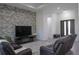 Bright living room showcases a stone accent wall, modern furnishings, and an open floor plan at 8045 Bosco Rd, Port Charlotte, FL 33981