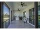 Inviting screened lanai featuring a built-in bar and grill, ceiling fans, and a serene outdoor ambiance at 8045 Bosco Rd, Port Charlotte, FL 33981
