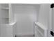 Walk-in closet with built-in white shelves, cabinets, and drawers for ample storage at 8045 Bosco Rd, Port Charlotte, FL 33981