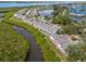 Aerial view of a waterfront home in a community with water access and lush landscaping at 805 Waterside Ln, Bradenton, FL 34209