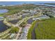 Aerial view of condo community showcasing landscaping, pools, ponds, and surrounding lush vegetation at 805 Waterside Ln, Bradenton, FL 34209