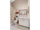 Neutral bathroom with white cabinets, a framed mirror, and a tropical-themed shower curtain at 805 Waterside Ln, Bradenton, FL 34209