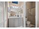 Well-lit bathroom with a gray vanity, neutral walls, and a glass-enclosed shower at 805 Waterside Ln, Bradenton, FL 34209