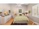 Bright bedroom with vaulted ceiling, tropical decor, and a window letting in natural light at 805 Waterside Ln, Bradenton, FL 34209