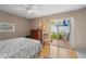 Cozy bedroom featuring a sliding door to a private patio and hardwood floors at 805 Waterside Ln, Bradenton, FL 34209