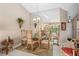Elegant dining area with chandelier and mirrored wall open to the living room at 805 Waterside Ln, Bradenton, FL 34209