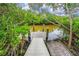 Tranquil dock offering a serene spot to enjoy nature and the waterfront views surrounded by lush greenery at 805 Waterside Ln, Bradenton, FL 34209