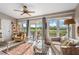Inviting living room with a ceiling fan and sliding glass doors to a patio at 805 Waterside Ln, Bradenton, FL 34209