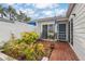 Cozy outdoor patio with brick pavers, seating, and lush tropical landscaping at 805 Waterside Ln, Bradenton, FL 34209