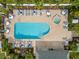 Aerial shot of a community pool with lounge chairs, umbrellas, and a hot tub at 805 Waterside Ln, Bradenton, FL 34209