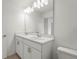 Well-lit bathroom with double sinks, white cabinetry, and a large mirror at 8705 Winter Breeze Way, Sarasota, FL 34241