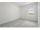 Neutral bedroom with a window overlooking outdoor views, providing natural light at 8705 Winter Breeze Way, Sarasota, FL 34241