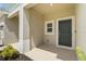 Inviting covered entryway features neutral paint and landscaping at 8705 Winter Breeze Way, Sarasota, FL 34241