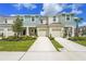 Two-story townhome featuring a single-car garage, neutral paint, and manicured landscaping at 8705 Winter Breeze Way, Sarasota, FL 34241