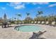 Inviting hot tub surrounded by lounge chairs, umbrellas, and beautiful tropical landscaping for a perfect retreat at 8705 Winter Breeze Way, Sarasota, FL 34241