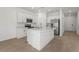 New kitchen with stainless appliances, a large island, quartz countertops, and ample cabinet space at 8705 Winter Breeze Way, Sarasota, FL 34241