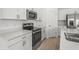 Bright kitchen featuring stainless steel appliances, quartz countertops, and modern fixtures at 8705 Winter Breeze Way, Sarasota, FL 34241