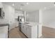 Modern kitchen features a center island with a sink, stainless steel appliances, and a walk-in pantry at 8705 Winter Breeze Way, Sarasota, FL 34241
