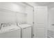 Convenient laundry room features a washer, dryer, and wire shelving for organized storage at 8705 Winter Breeze Way, Sarasota, FL 34241