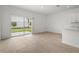 Spacious living area with sliding glass doors offering access to the outdoor patio and backyard at 8705 Winter Breeze Way, Sarasota, FL 34241