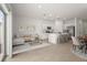 Bright, open-concept living space with kitchen, dining and living area with a sliding glass door at 8705 Winter Breeze Way, Sarasota, FL 34241