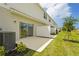 Private outdoor patio with lush green grass, privacy fence, and slider door entry at 8705 Winter Breeze Way, Sarasota, FL 34241