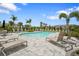 Inviting community pool surrounded by lounge chairs and lush landscaping for resort-style living at 8705 Winter Breeze Way, Sarasota, FL 34241
