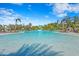 Stunning lagoon-style pool surrounded by lush landscaping and relaxing cabanas on a beautiful day at 8705 Winter Breeze Way, Sarasota, FL 34241