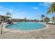 Beautiful community pool with ample seating, palm trees, and a splash pad for Gathering fun in the sun at 8705 Winter Breeze Way, Sarasota, FL 34241