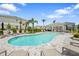 Community swimming pool with lounge chairs, a pavilion, palm trees, and a gray brick surround at 8705 Winter Breeze Way, Sarasota, FL 34241