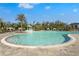 Gorgeous community pool featuring a splash pad, poolside lounge chairs and tropical landscaping for a relaxing oasis at 8705 Winter Breeze Way, Sarasota, FL 34241
