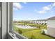 Exterior view from the window featuring a serene pond surrounded by manicured landscaping at 8705 Winter Breeze Way, Sarasota, FL 34241