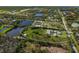 Captivating aerial view of a lush neighborhood featuring multiple ponds, greenery, and scattered residences at 1408 99Th Nw St, Bradenton, FL 34209