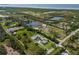 Breathtaking aerial shot showcasing a large estate nestled amidst serene lakes and verdant landscapes at 1408 99Th Nw St, Bradenton, FL 34209
