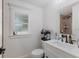 Bright bathroom with a window, large mirror, vanity and a walk-in shower with decorative tile at 1408 99Th Nw St, Bradenton, FL 34209