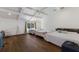 Bright bedroom features hardwood floors and a cozy seating area with backyard views at 1408 99Th Nw St, Bradenton, FL 34209