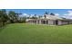 Beautiful home featuring a white exterior, large lawn, and screened-in porch area at 1408 99Th Nw St, Bradenton, FL 34209