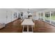 Expansive living area features wood floors, fireplace, and multiple access points to the outdoors at 1408 99Th Nw St, Bradenton, FL 34209