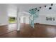 Open living room with hardwood floors, a spiral staircase, and large windows for ample natural light at 1408 99Th Nw St, Bradenton, FL 34209
