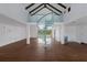 Spacious living room featuring high ceilings, exposed beams, and a unique spiral staircase at 1408 99Th Nw St, Bradenton, FL 34209