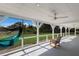 Relaxing screened-in porch featuring a hammock and comfortable rocking chair at 1408 99Th Nw St, Bradenton, FL 34209