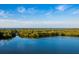 Beautiful water view surrounded by lush greenery under a blue sky and distant bridge at 1408 99Th Nw St, Bradenton, FL 34209