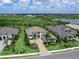 Aerial front view of a two-story home with mature landscaping, paved driveway, and 3-car garage at 16917 Clearlake Ave, Lakewood Ranch, FL 34202