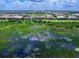 Aerial view of home and pool across marsh from water at 16917 Clearlake Ave, Lakewood Ranch, FL 34202