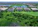 Aerial view of home from across marsh with pool and lake views at 16917 Clearlake Ave, Lakewood Ranch, FL 34202