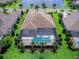 Aerial view of home with lanai, pool, and manicured lawn at 16917 Clearlake Ave, Lakewood Ranch, FL 34202