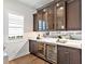 Elegant bar area with wine coolers, mirrored backsplash, and custom cabinets at 16917 Clearlake Ave, Lakewood Ranch, FL 34202