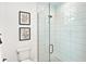 Bright bathroom with glass shower door, white tiled walls, and modern decor at 16917 Clearlake Ave, Lakewood Ranch, FL 34202