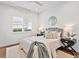 A light and bright bedroom featuring a queen sized bed and minimalistic decor at 16917 Clearlake Ave, Lakewood Ranch, FL 34202